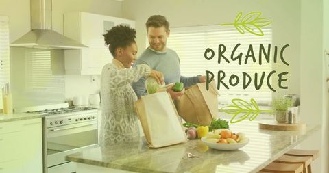 Diverse couple preparing meal with organic produce in modern kitchen