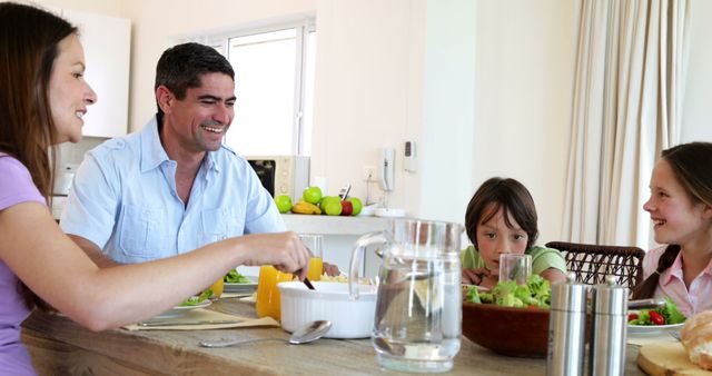 Happy Family Eating Salad Together at Home - Download Free Stock Images Pikwizard.com