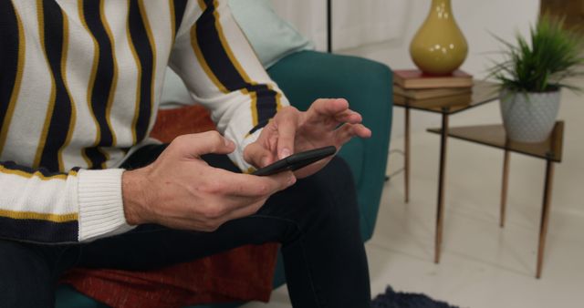 Close-up of Person Using Smartphone at Home in Modern Living Room - Download Free Stock Images Pikwizard.com