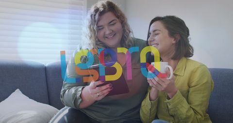 Happy Lesbian Couple Using Tablet Supporting LGBTQ Rights at Home