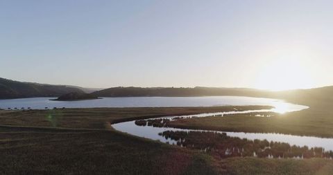 Peaceful Sunrise Over Serene Lake and Rolling Hills - Download Free Stock Images Pikwizard.com