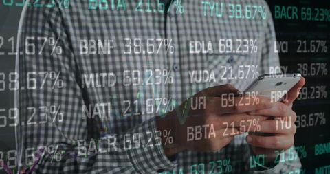Businessman Using Smartphone Amidst Financial Data Graphics
