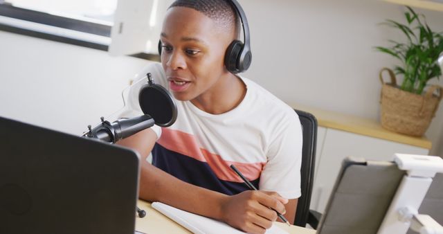 Teenager Podcasting at Desk and Writing Notes - Download Free Stock Images Pikwizard.com