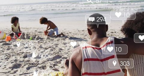 Family relaxing on sunlit beach with social media notification overlays and children playing