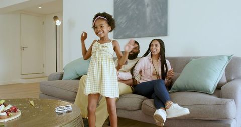 Joyful Family Day in Cozy Living Room Setting with Delighted Child