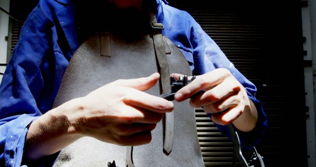 Worker in Protective Apron Assembling Tool in Workshop - Download Free Stock Images Pikwizard.com