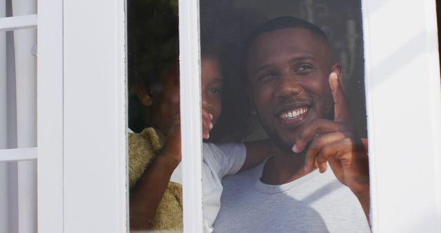 Father and Daughter Smiling and Pointing Out Window - Download Free Stock Images Pikwizard.com