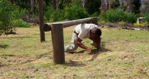 Man in Military Training Crawling in Outdoor Obstacle Course - Download Free Stock Images Pikwizard.com