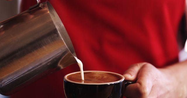 Barista pouring milk into steaming hot coffee cup - Download Free Stock Images Pikwizard.com