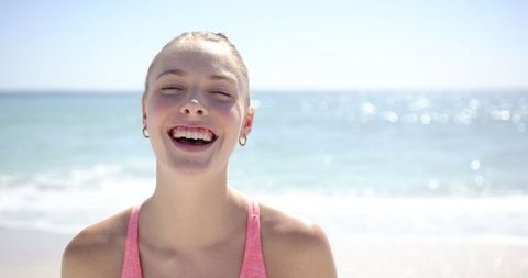Joyous Woman Smiling on Sunny Beach Day