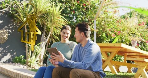 Happy couple in garden discussing real estate concepts