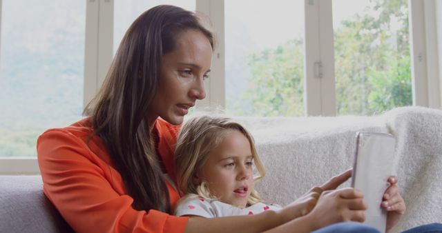 Mother and Daughter Using Tablet on Couch - Download Free Stock Images Pikwizard.com