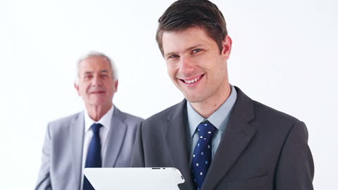 Executives Engaged with Tablet Technology in White Office Environment