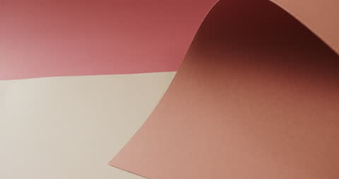 Close Up of Layered Papers on Soft Red and Beige Background
