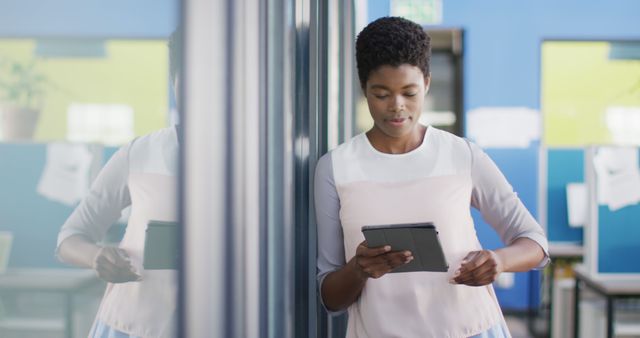 Focused Businesswoman Using Digital Tablet in Office Corridor - Download Free Stock Images Pikwizard.com