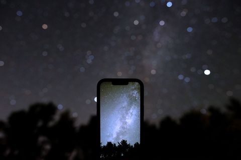 Technology smartphone displays starscape with night sky backdrop
