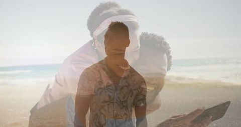 Smiling man wearing floral shirt standing on beach with couple sharing phone overlay