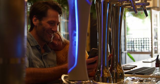 Couple Enjoying Time at Bar With Modern Beer Taps - Download Free Stock Images Pikwizard.com