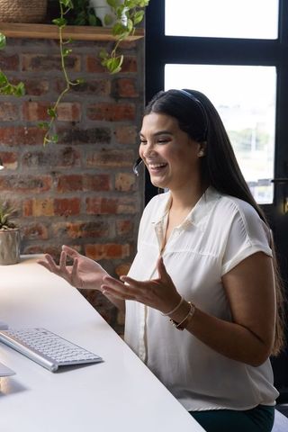 Professional Woman Communicating with Headset in Modern Office