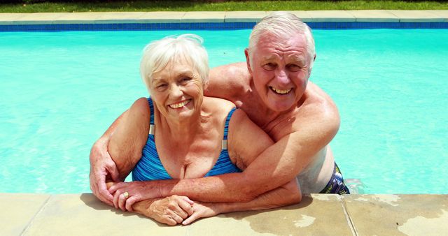 Happy Senior Couple Embracing While Swimming in Pool on Sunny Day - Download Free Stock Images Pikwizard.com