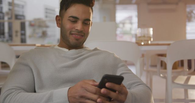 Smiling Man Using Smartphone in Modern Cafe - Download Free Stock Images Pikwizard.com