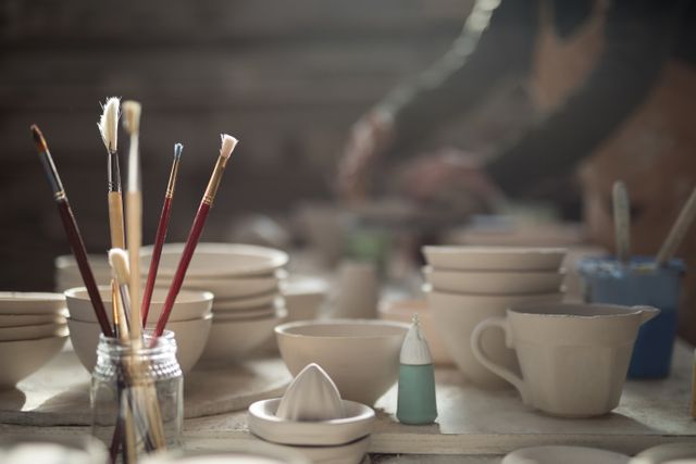Art Studio with Paint Brushes and Ceramic Bowls - Download Free Stock Photos Pikwizard.com