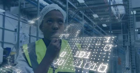 Technician analyzing holographic data overlay in smart factory production floor