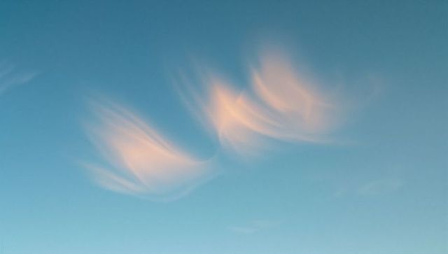 Serene sunset with wispy clouds in blue sky