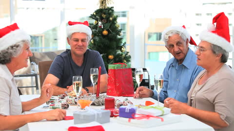 Seniors Celebrating Christmas with Gifts and Festive Hats