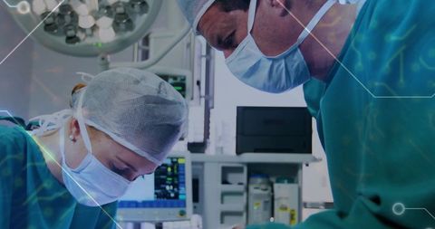 Surgeons in operation room performing precise surgical procedure