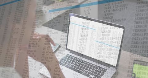 Mid-adult woman checking phone while reviewing laptop spreadsheet data with error overlay