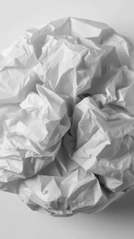 Vertical Macro Video Showing Crumpled White Paper Texture with Deep Folds and Soft Studio Lighting