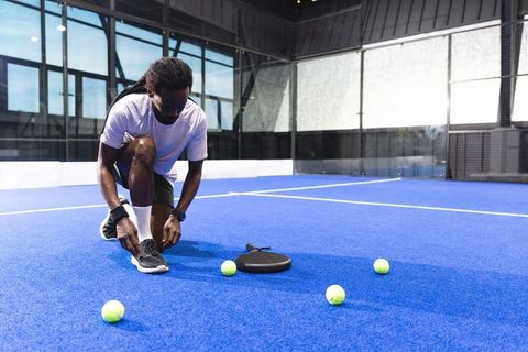 African American Athlete Preparing on Blue Padel Court