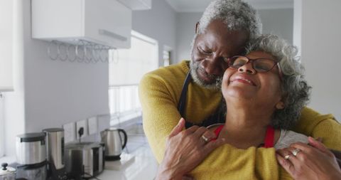 Joyful Senior African American Couple Embracing in Modern Kitchen