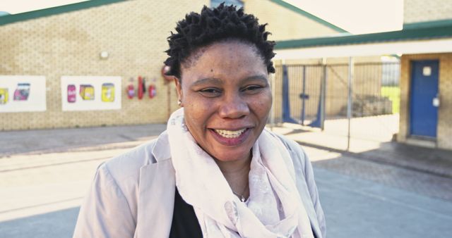 Confident African Woman Smiling Outdoors at Daycare Center - Download Free Stock Images Pikwizard.com