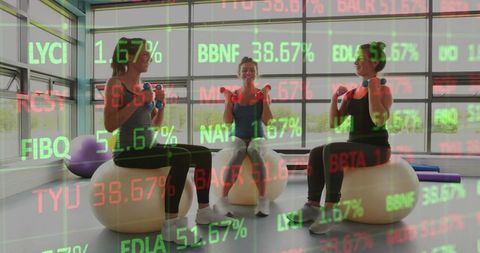 Three women performing stability ball arm curls with dumbbells in gym stock ticker overlay