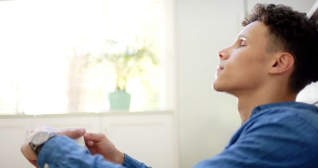 Man Relaxing Indoors With Eyes Closed, Occupied Hands - Download Free Stock Images Pikwizard.com