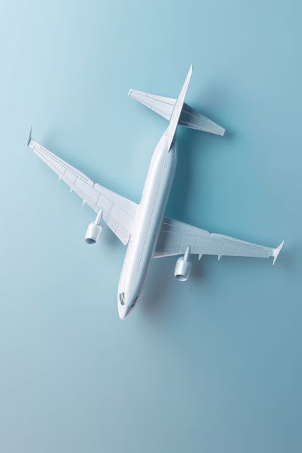 White passenger jet plane on blue background with copy space, created using generative ai technology. Air transport, travel and vacations, digitally generated image.