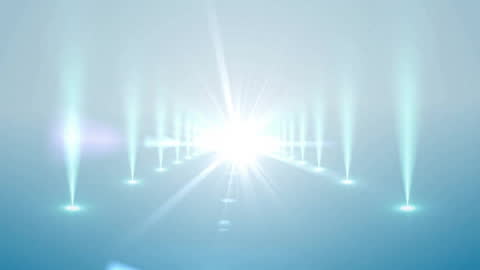 Dynamic Spotlights Creating Radiant Light Trails on Blue Background