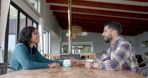 Happy Couple Sharing Coffee and Conversation at Home