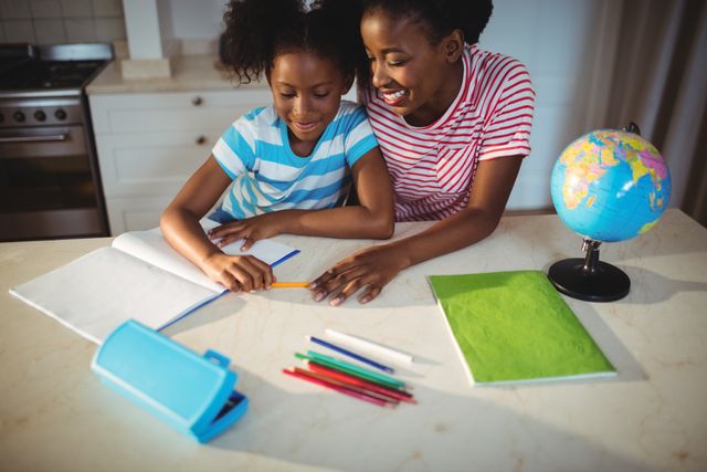 Mother assisting daughter with homework at kitchen counter. Ideal for educational materials, family and parenting blogs, advertisements promoting educational products, or articles on parent-child bonding and home learning environments.