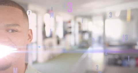 Smiling young man posing in bright coworking space with futuristic numeric overlay