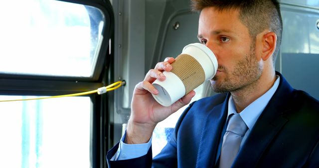 Businessman Commuting to Work on Bus Drinking Coffee - Download Free Stock Images Pikwizard.com