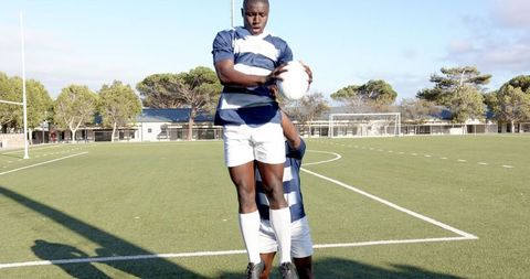 Rugby Players Executing Lineout Catch on Green Field