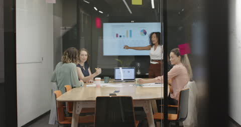 Diverse Team Analyzing Data and Strategy in Meeting Room