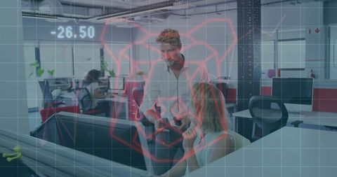 Coworkers analyzing digital interface in modern office space