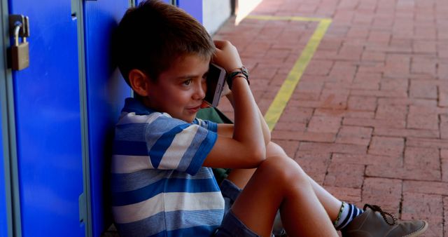 Sad Boy Sitting on School Corridor Floor Near Lockers - Download Free Stock Images Pikwizard.com