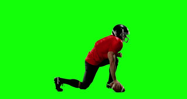 American football player wearing red jersey, black pants, and helmet, preparing to snap ball on green screen background. Useful for editing and adding custom backgrounds, ideal for sports advertisements, training videos, and graphic design. Perfect for creating sports promotions and dynamic action scenes.