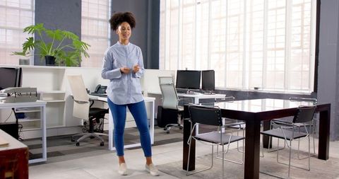 Confident woman presenting in bright modern office space