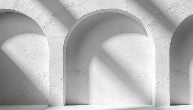 Framing Central Arch in Minimalist White Gallery with Diagonal Light and Textured Plaster